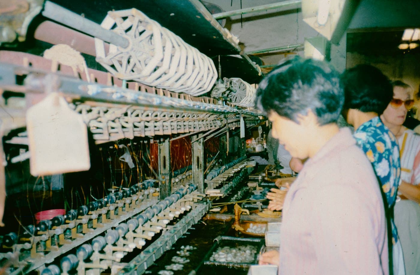 Workers at machines in a textile factory