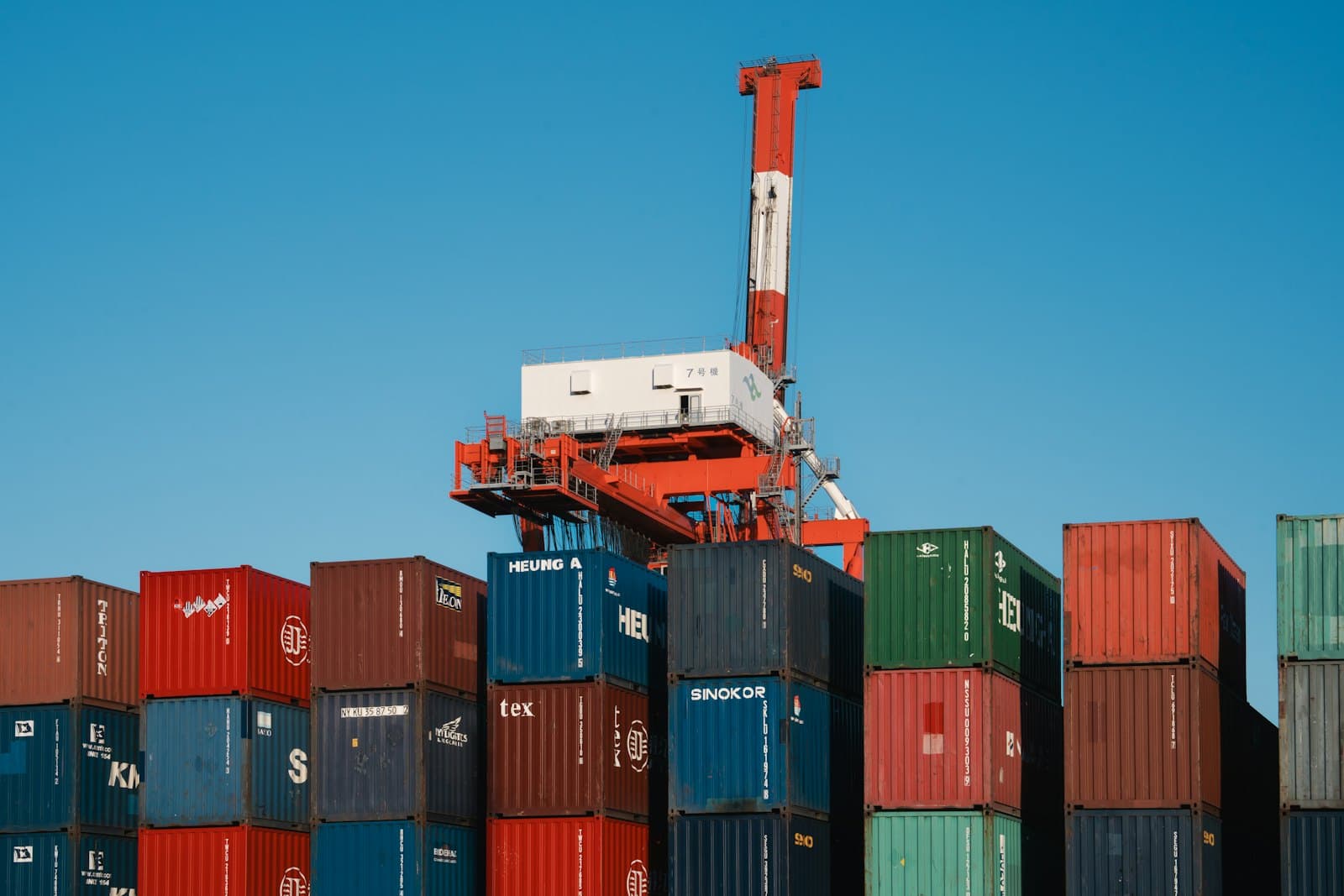 A crane above stacked containers