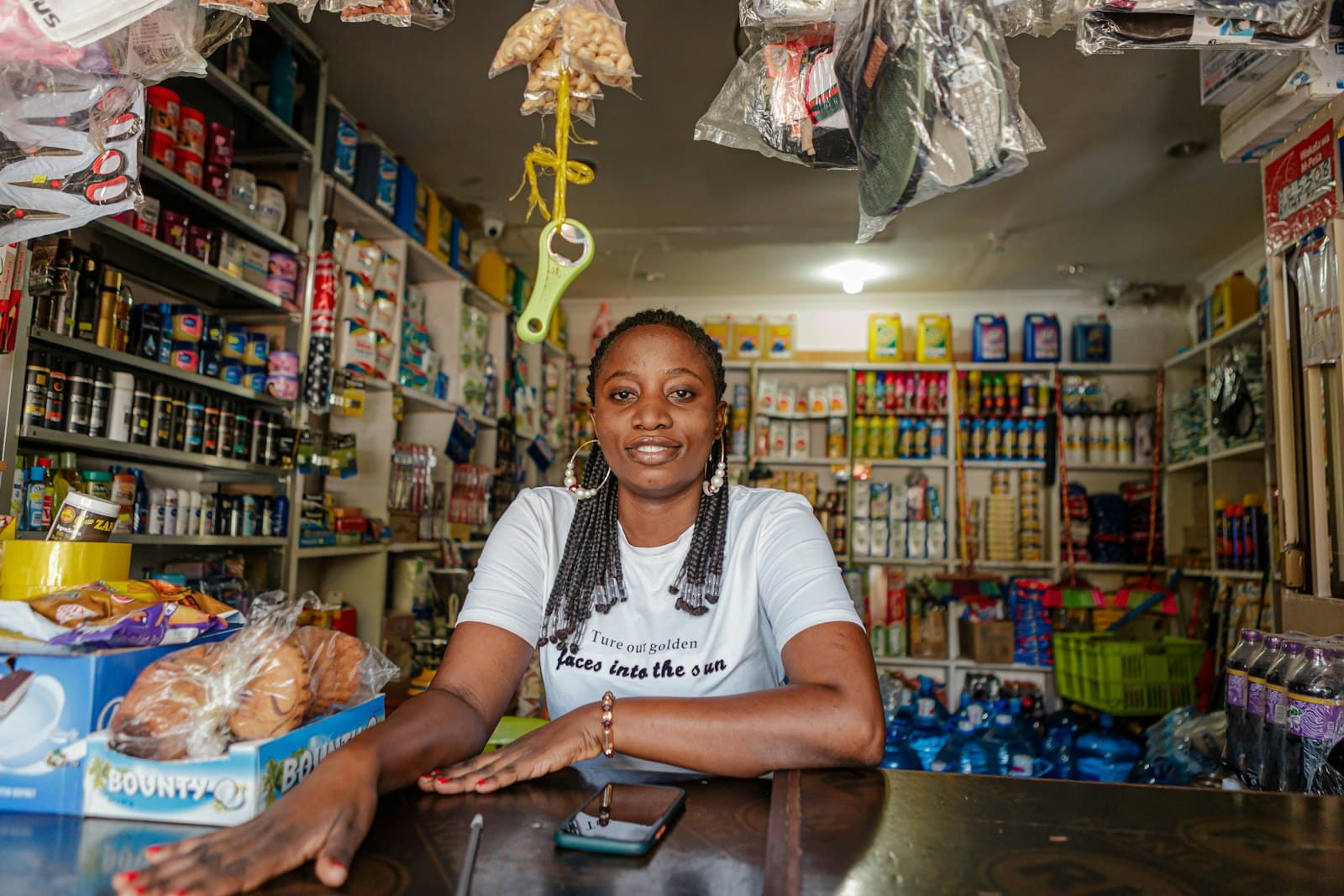 A shopkeeper at the counter of her shop