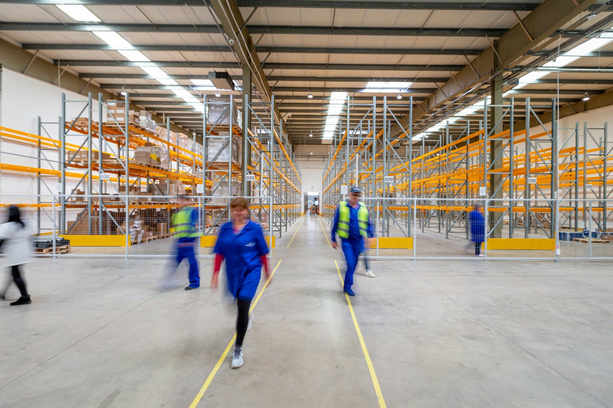 Warehouse staff walking an aisle